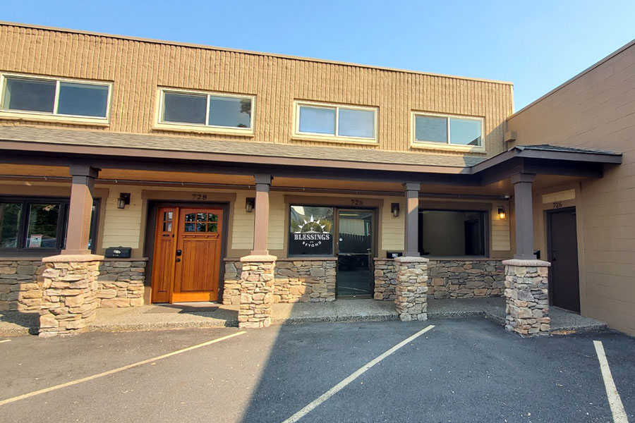 Building exterior with stone pillars and windows.