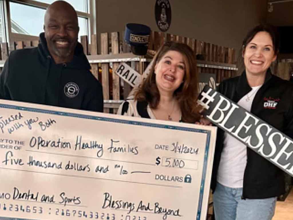 Blessings and Beyond giving a check to Operation Healthy Families