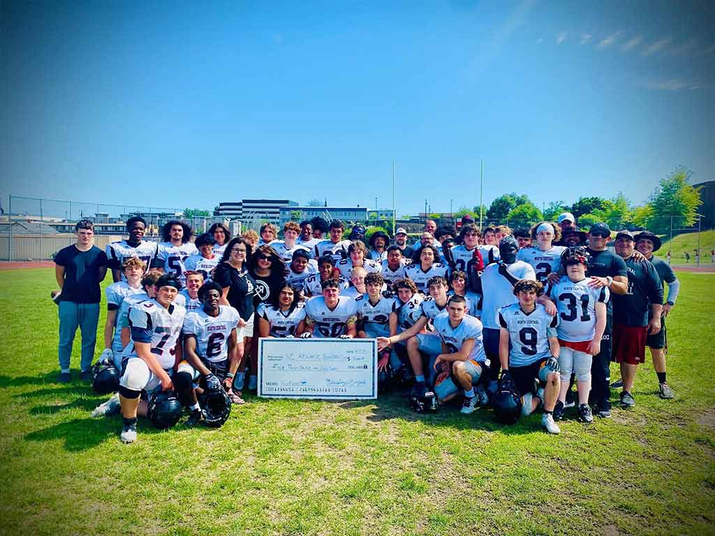 Blessings presenting a check to North Central High School Football Team