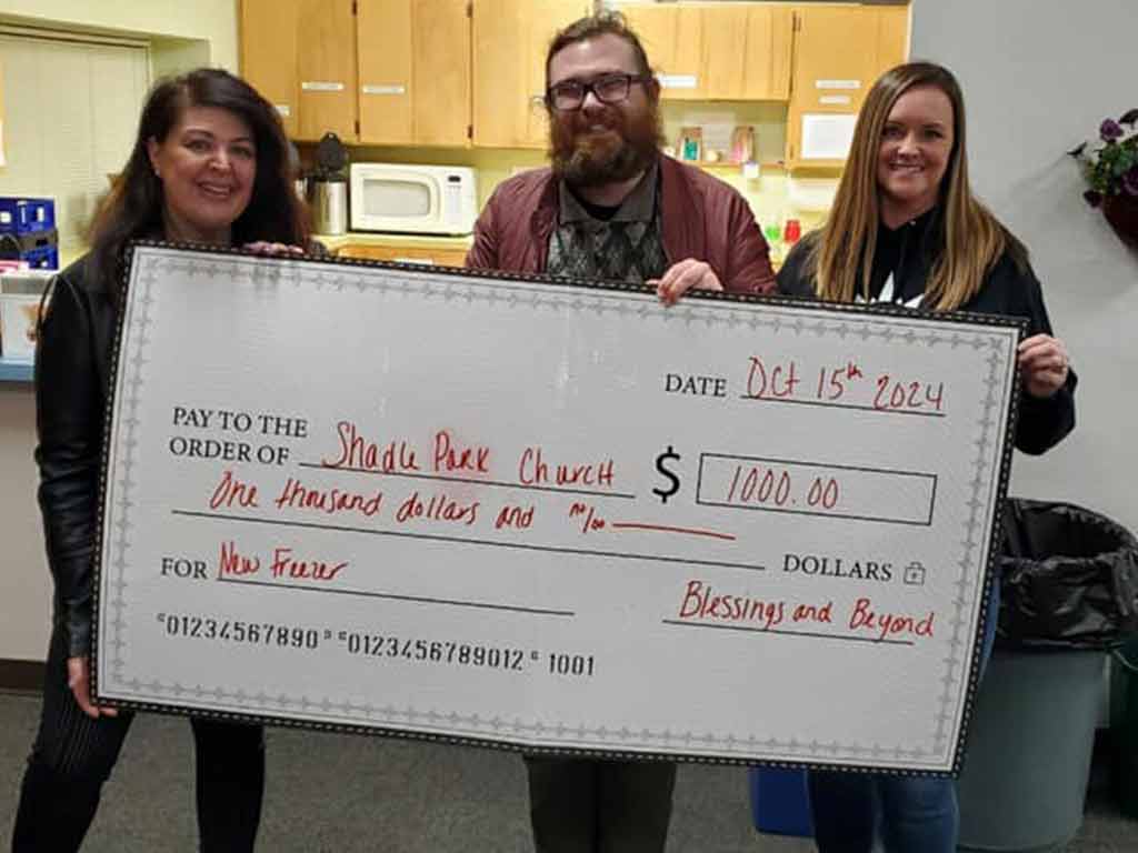 Blessings and Beyond giving a check to Shadle Park Presbyterian Church